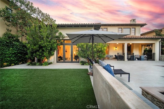 16 Seawatch, Newport Coast, CA 92657 - rear view of house with stucco siding, a lawn, and a chimney