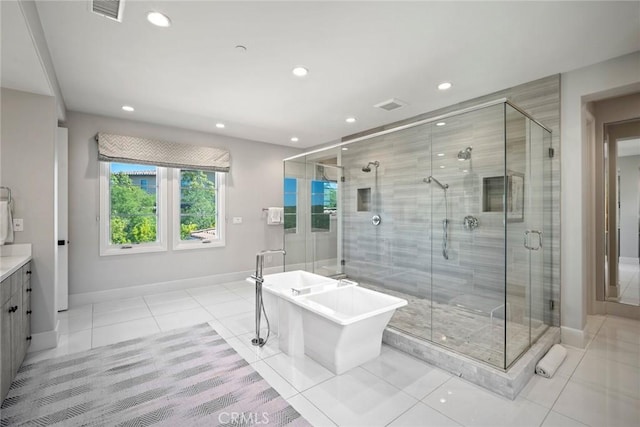 16 Seawatch, Newport Coast, CA 92657 - full bath featuring tile patterned flooring, vanity, recessed lighting, a soaking tub, and a shower stall