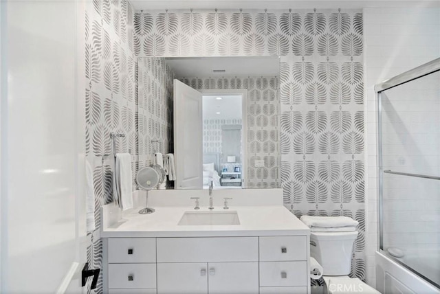 16 Seawatch, Newport Coast, CA 92657 - ensuite bathroom featuring wallpapered walls, vanity, and shower / bath combination with glass door