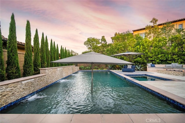 16 Seawatch, Newport Coast, CA 92657 - pool at dusk featuring an in-ground hot tub, an outdoor pool, and a patio area