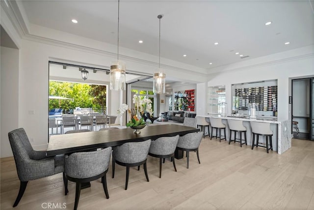 16 Seawatch, Newport Coast, CA 92657 - dining space with light wood-style floors, a community bar, crown molding, a tray ceiling, and recessed lighting