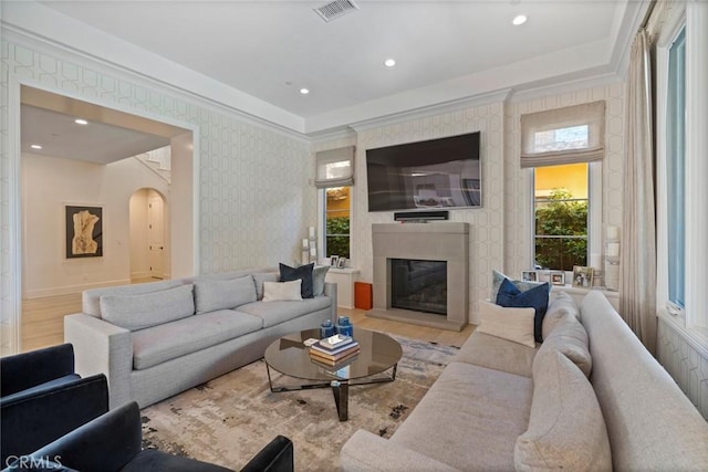 16 Seawatch, Newport Coast, CA 92657 - living room featuring arched walkways, wallpapered walls, a glass covered fireplace, wood finished floors, and recessed lighting