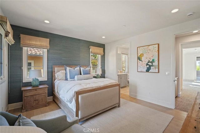 16 Seawatch, Newport Coast, CA 92657 - bedroom with light wood finished floors, multiple windows, recessed lighting, an accent wall, and ensuite bathroom