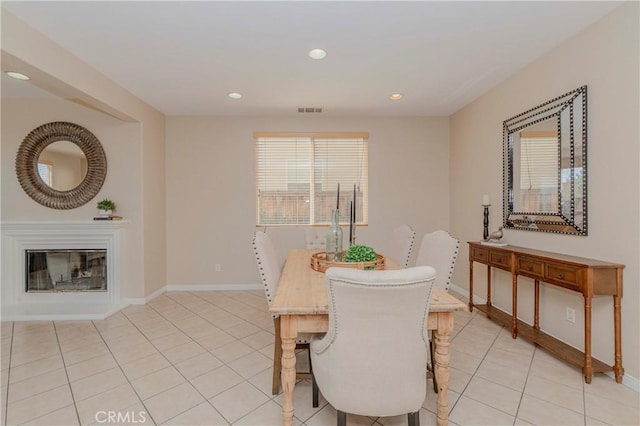 25228 Coral Canyon Rd, Corona, CA 92883 - dining space with light tile patterned floors, a glass covered fireplace, and recessed lighting