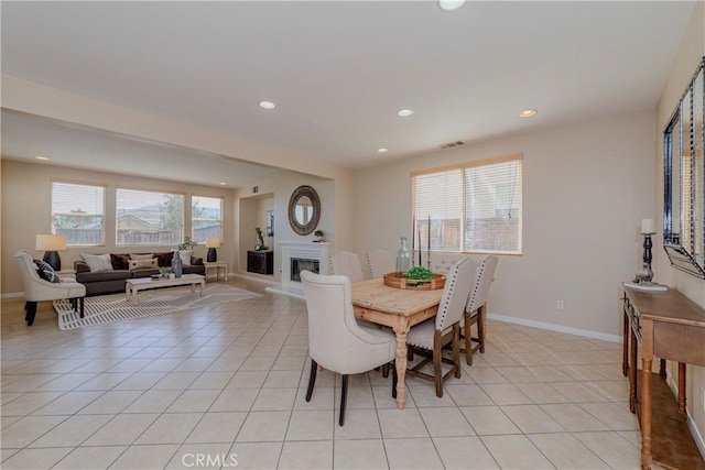 25228 Coral Canyon Rd, Corona, CA 92883 - dining space with recessed lighting, light tile patterned flooring, and a glass covered fireplace