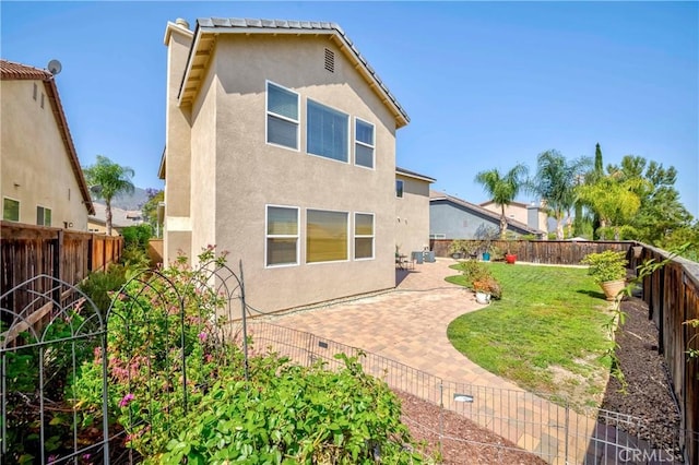 25228 Coral Canyon Rd, Corona, CA 92883 - rear view of property with stucco siding, a fenced backyard, and a patio