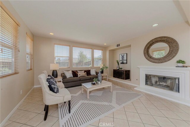 25228 Coral Canyon Rd, Corona, CA 92883 - living area featuring light tile patterned flooring, a glass covered fireplace, and recessed lighting
