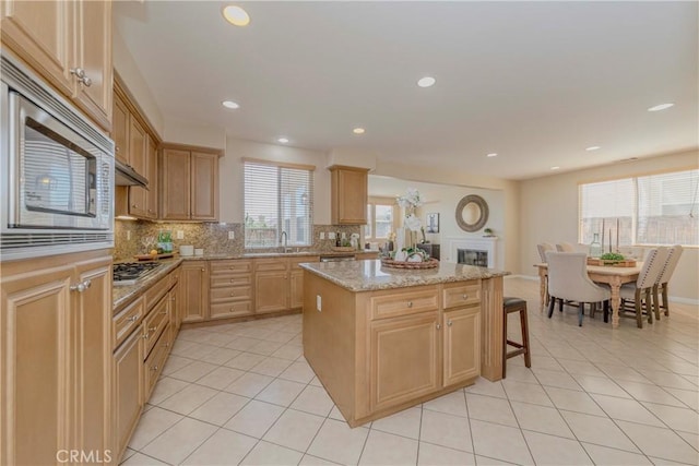 25228 Coral Canyon Rd, Corona, CA 92883 - kitchen with a center island, light tile patterned floors, tasteful backsplash, stainless steel appliances, and recessed lighting