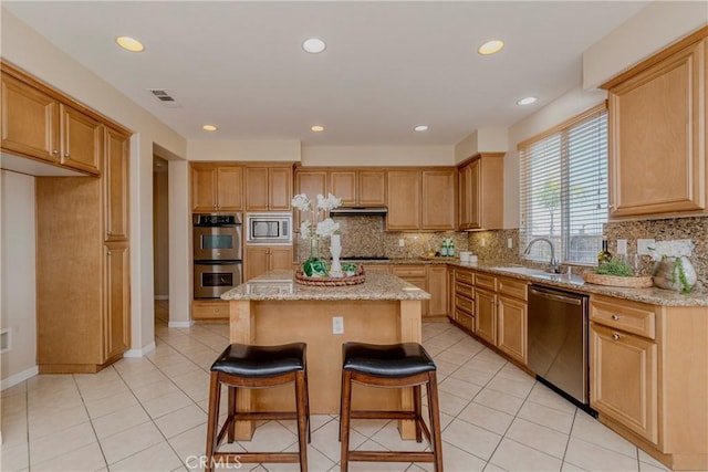 25228 Coral Canyon Rd, Corona, CA 92883 - kitchen with stainless steel appliances, a kitchen island, decorative backsplash, light stone counters, and recessed lighting