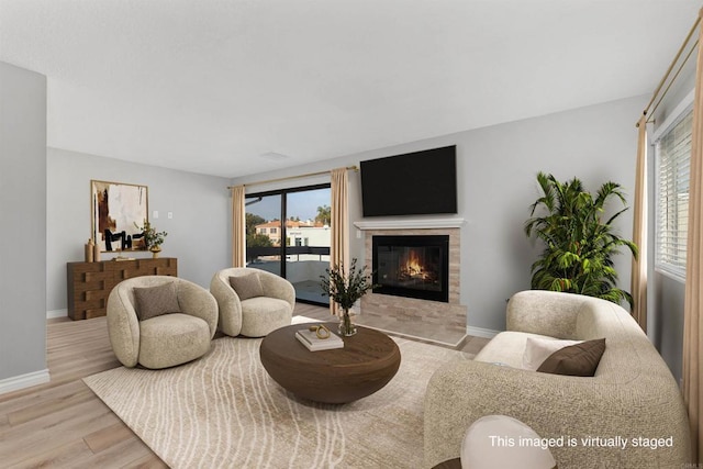 7528 Jerez Ct Unit 6, Carlsbad, CA 92009 - living area featuring wood finished floors, plenty of natural light, and a tile fireplace