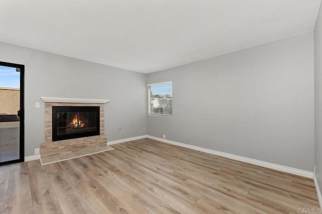 7528 Jerez Ct Unit 6, Carlsbad, CA 92009 - unfurnished living room with wood finished floors and a tile fireplace