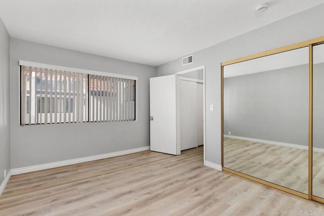 7528 Jerez Ct Unit 6, Carlsbad, CA 92009 - unfurnished bedroom featuring wood finished floors and baseboards