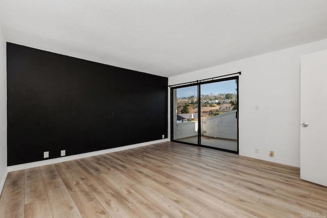 7528 Jerez Ct Unit 6, Carlsbad, CA 92009 - unfurnished room with light wood-style flooring and baseboards