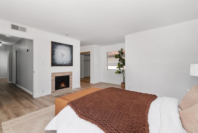7528 Jerez Ct Unit 6, Carlsbad, CA 92009 - bedroom featuring light wood finished floors, a fireplace, and a closet
