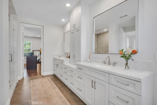 24234 Reyes Adobe Way, Valencia, CA 91354 - bathroom featuring double vanity, recessed lighting, and a shower with door