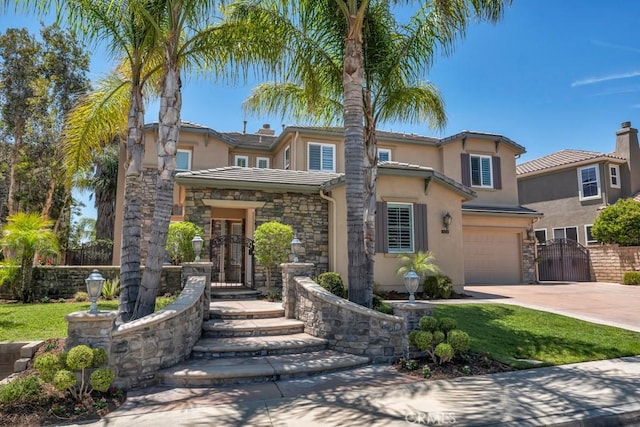 24234 Reyes Adobe Way, Valencia, CA 91354 - view of front of property with an attached garage, concrete driveway, stucco siding, and stone siding