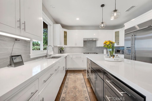 24234 Reyes Adobe Way, Valencia, CA 91354 - kitchen featuring stainless steel appliances, light countertops, decorative light fixtures, white cabinetry, and recessed lighting