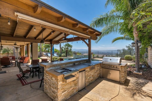 24234 Reyes Adobe Way, Valencia, CA 91354 - view of patio / terrace featuring exterior kitchen, a ceiling fan, and an outdoor living space
