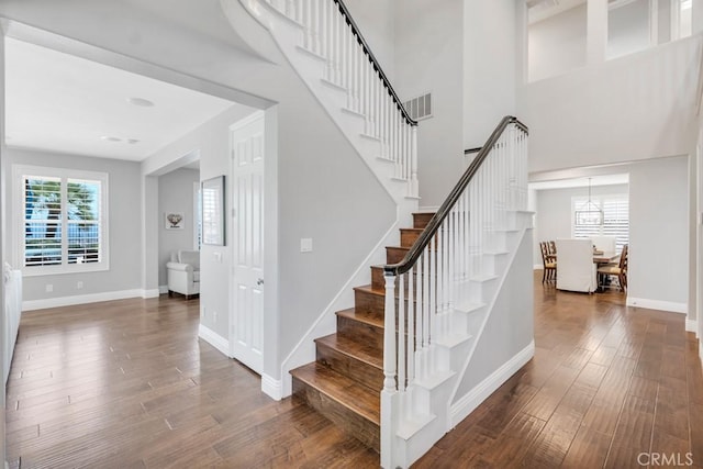 24234 Reyes Adobe Way, Valencia, CA 91354 - stairway with wood finished floors, plenty of natural light, and a chandelier