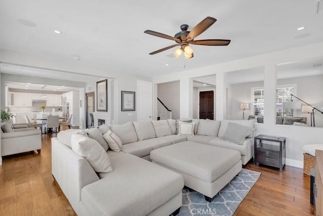 24234 Reyes Adobe Way, Valencia, CA 91354 - living area featuring ceiling fan, stairs, wood finished floors, and recessed lighting
