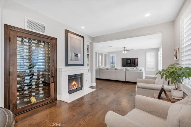 24234 Reyes Adobe Way, Valencia, CA 91354 - living room with dark wood-style flooring, a glass covered fireplace, recessed lighting, and ceiling fan