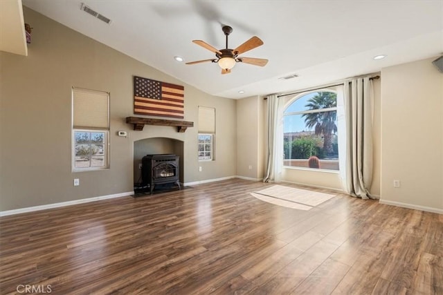 14296 Bieri St, Mojave, CA 93501 - unfurnished living room featuring ceiling fan, wood finished floors, vaulted ceiling, a wood stove, and recessed lighting