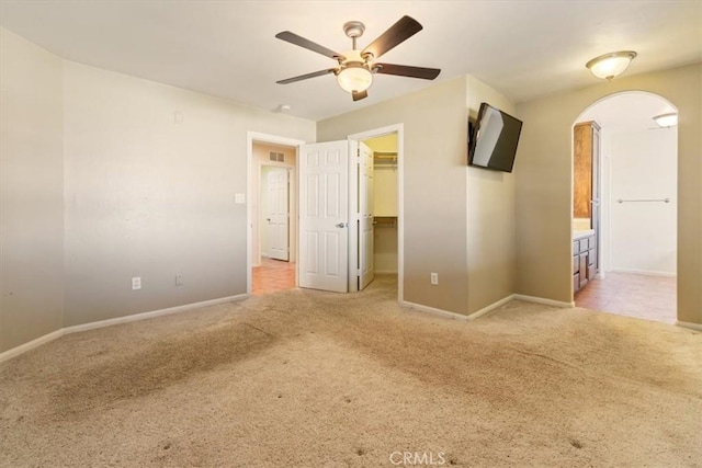 14296 Bieri St, Mojave, CA 93501 - empty room with light colored carpet, ceiling fan, and arched walkways