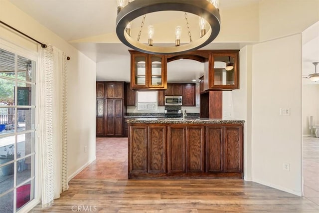 14296 Bieri St, Mojave, CA 93501 - kitchen with stainless steel appliances, wood finished floors, and glass insert cabinets