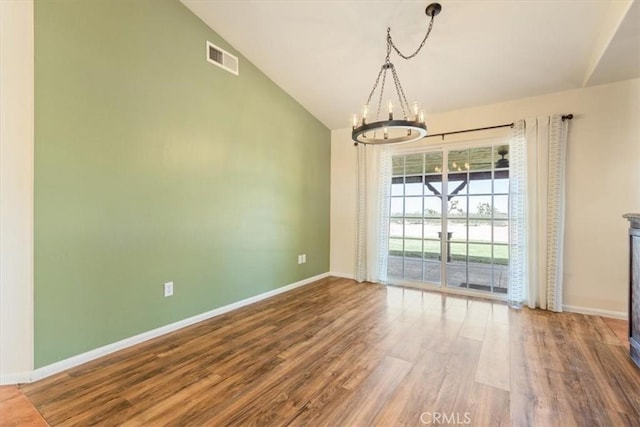 14296 Bieri St, Mojave, CA 93501 - unfurnished dining area featuring a chandelier, wood finished floors, and vaulted ceiling