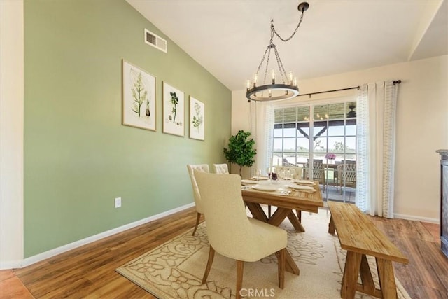 14296 Bieri St, Mojave, CA 93501 - dining area with a chandelier, wood finished floors, and lofted ceiling