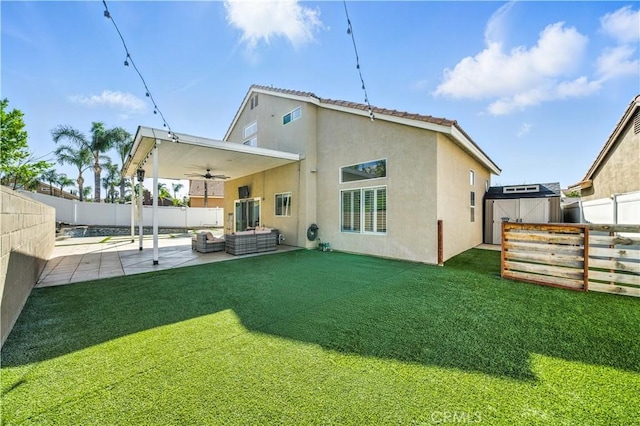 33175 Camino Maraca, Temecula, CA 92592 - back of property with ceiling fan, a fenced backyard, an outdoor hangout area, a patio area, and stucco siding