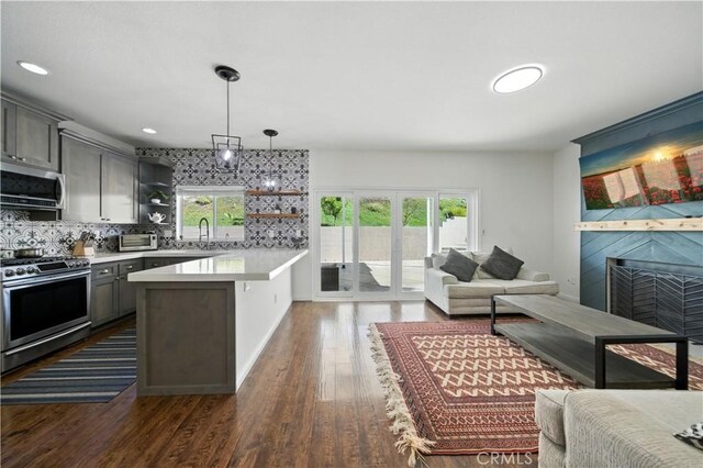 33175 Camino Maraca, Temecula, CA 92592 - kitchen featuring appliances with stainless steel finishes, open floor plan, open shelves, light countertops, and recessed lighting