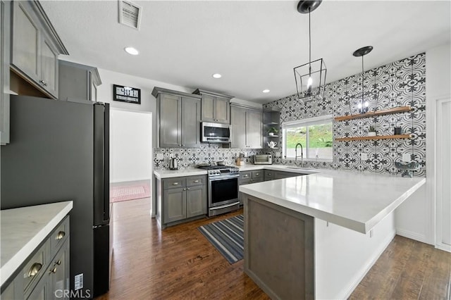 33175 Camino Maraca, Temecula, CA 92592 - kitchen featuring stainless steel appliances, open shelves, a peninsula, gray cabinets, and dark wood finished floors