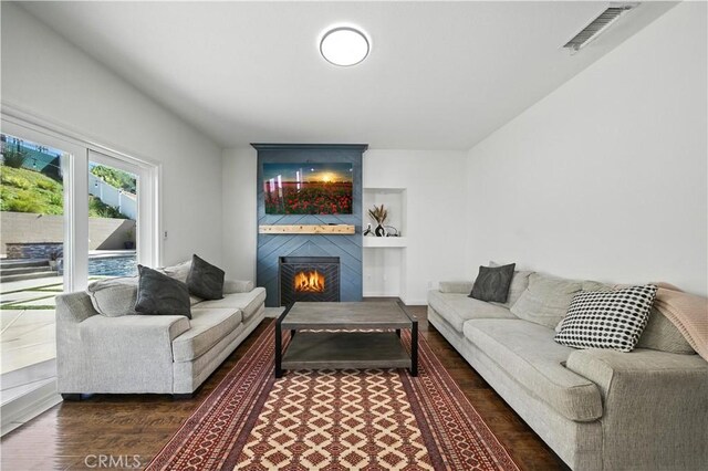 33175 Camino Maraca, Temecula, CA 92592 - living area with wood finished floors, a fireplace, and built in shelves