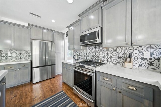 33175 Camino Maraca, Temecula, CA 92592 - kitchen with stainless steel appliances, gray cabinets, light countertops, backsplash, and recessed lighting
