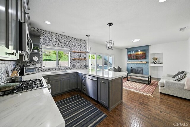 33175 Camino Maraca, Temecula, CA 92592 - kitchen with stainless steel appliances, open floor plan, open shelves, a peninsula, and light countertops