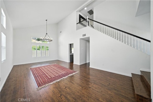 33175 Camino Maraca, Temecula, CA 92592 - unfurnished living room featuring stairs, high vaulted ceiling, wood finished floors, and a chandelier