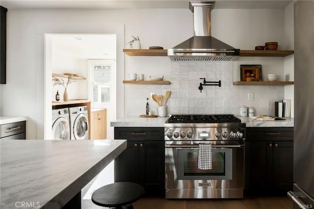 3702 Seneca Ave, Los Angeles, CA 90039 - kitchen with stainless steel range, wall chimney exhaust hood, washing machine and clothes dryer, open shelves, and tasteful backsplash