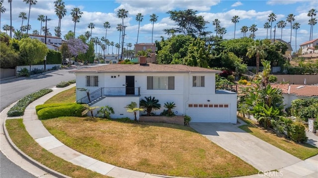 3704 Lorado Way, View Park, CA 90043 - view of front facade with concrete driveway, a garage, a front lawn, and stucco siding