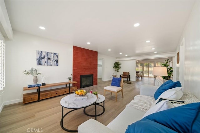 3704 Lorado Way, View Park, CA 90043 - living room featuring light wood-type flooring, a brick fireplace, and recessed lighting