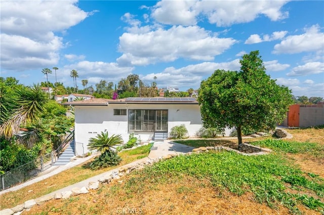 3704 Lorado Way, View Park, CA 90043 - back of house featuring stucco siding, solar panels, and stairway