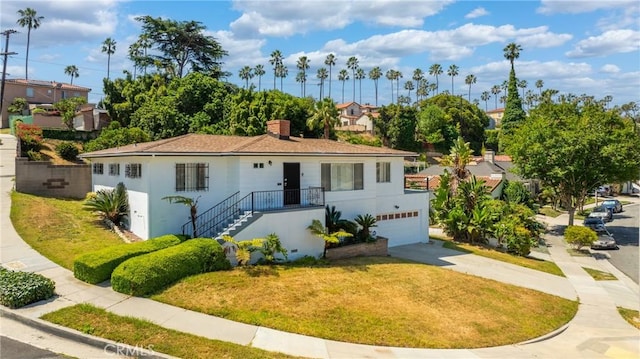 3704 Lorado Way, View Park, CA 90043 - view of front of property with driveway, an attached garage, a front lawn, and a chimney