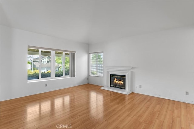 44051 Sheldon Ct, Temecula, CA 92592 - unfurnished living room with light wood finished floors and a glass covered fireplace