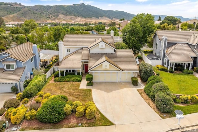 44051 Sheldon Ct, Temecula, CA 92592 - view of front facade with a tiled roof, a chimney, a garage, driveway, and a mountain view