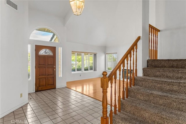 44051 Sheldon Ct, Temecula, CA 92592 - entryway with high vaulted ceiling, stairway, and light tile patterned floors