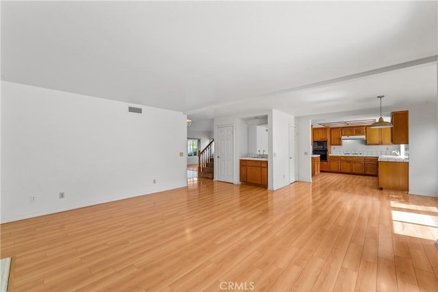 44051 Sheldon Ct, Temecula, CA 92592 - unfurnished living room with light wood finished floors and stairs