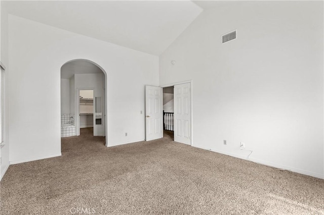 44051 Sheldon Ct, Temecula, CA 92592 - unfurnished bedroom with carpet floors, high vaulted ceiling, a closet, arched walkways, and a walk in closet