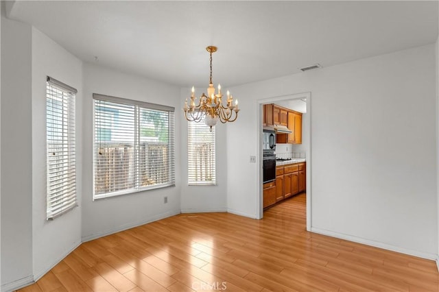 44051 Sheldon Ct, Temecula, CA 92592 - unfurnished dining area featuring a chandelier and light wood finished floors