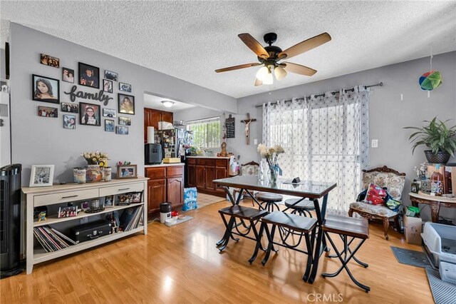 2660 Newell St, County Los Angeles, CA 90039 - dining space featuring a textured ceiling, light wood-style flooring, and a ceiling fan