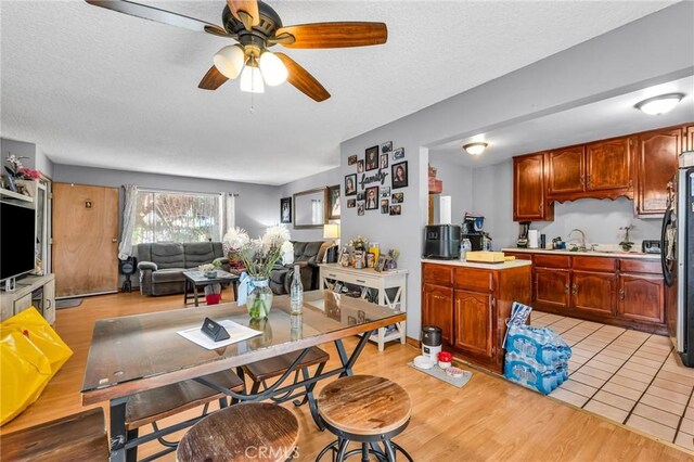 2660 Newell St, County Los Angeles, CA 90039 - kitchen with light countertops, a textured ceiling, ceiling fan, open floor plan, and light wood-style floors